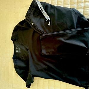 Black set of scrubs by FIGS.